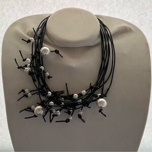 Designer created leather and pearl necklace.